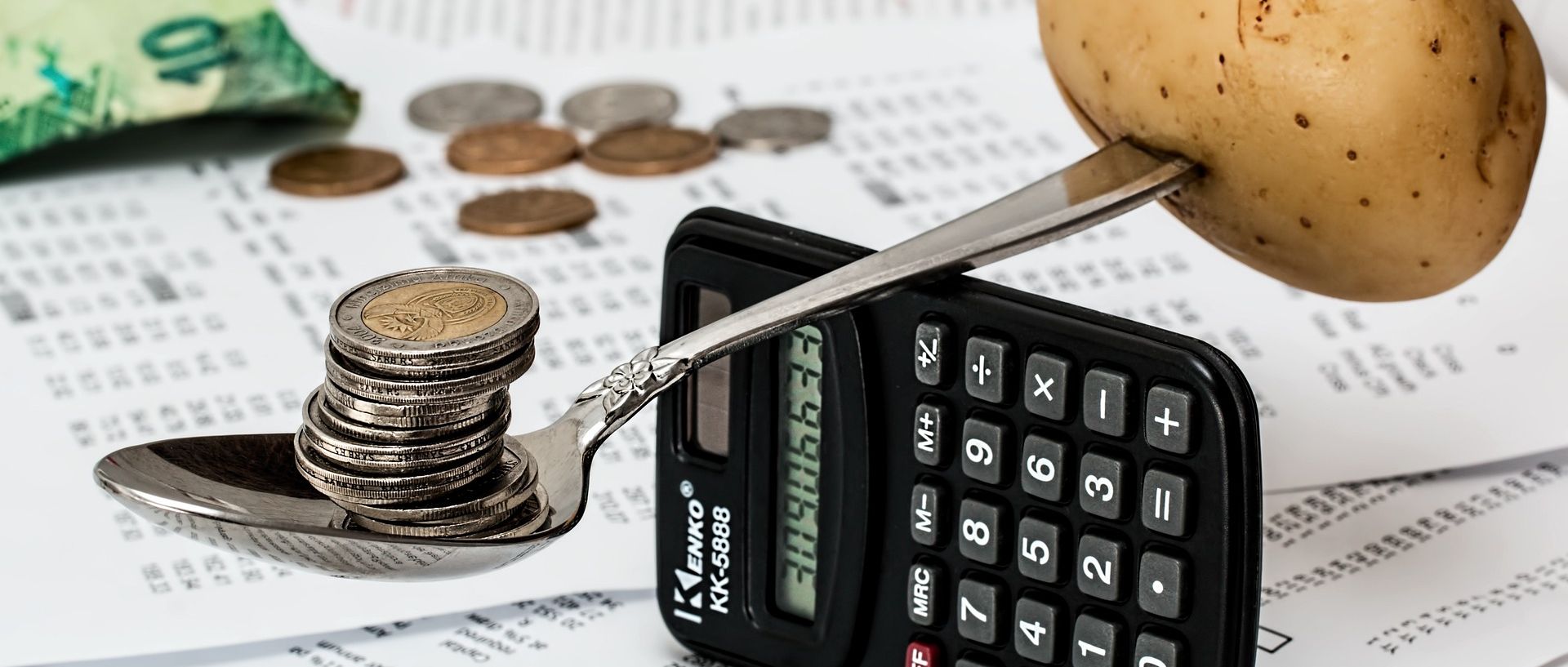 Symbolbild: Waage Geld, Kartoffel, Taschenrechner